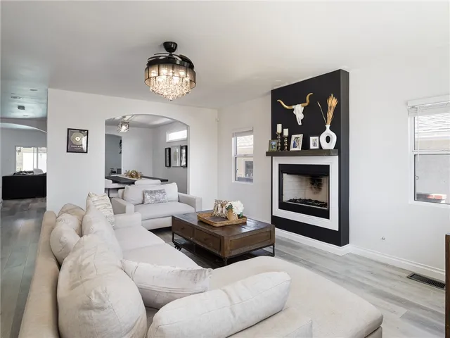 a living room with furniture a fireplace and a wall painting
