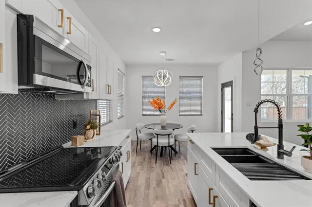 a bedroom with a bed flat screen tv and a window