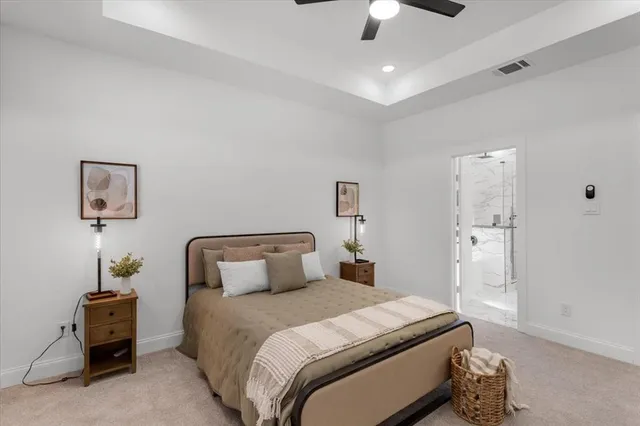 a bedroom with bed and a chandelier