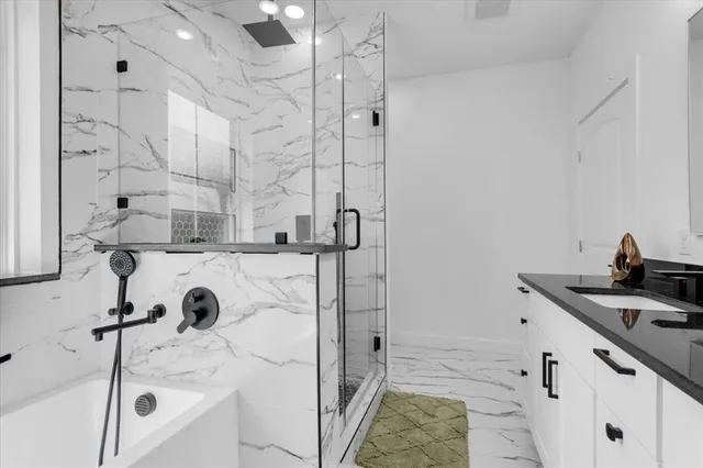 a bathroom with a bathtub and a shower