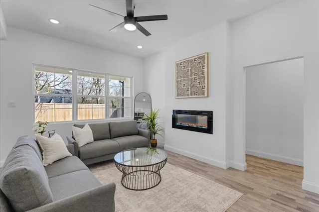 a living room with furniture and a potted plant