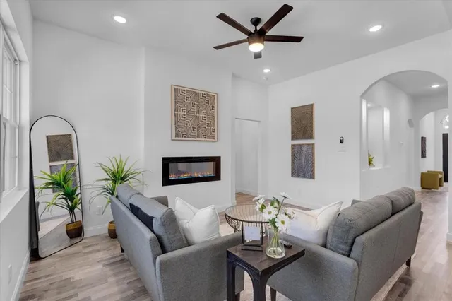 a living room with furniture kitchen and a large window