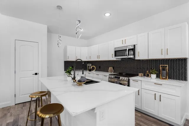 a kitchen with a sink a stove and microwave