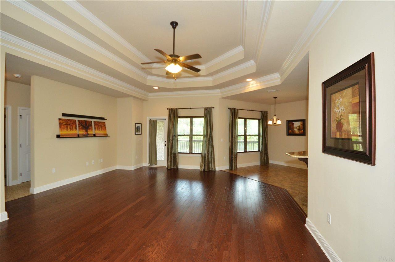 759 Lake Ridge Lane Pensacola, FL 32514 - Photo 11 of 43 a view of an empty room with wooden floor and a window