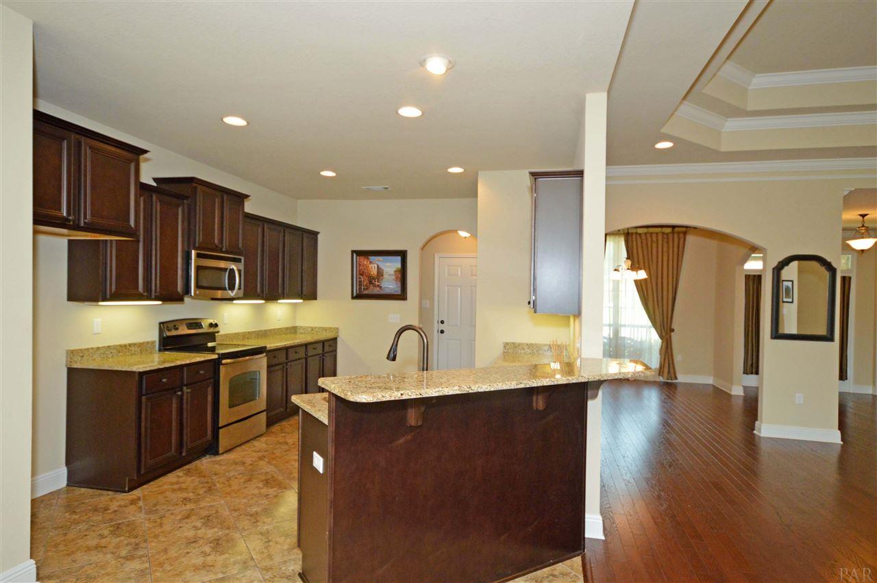 759 Lake Ridge Lane Pensacola, FL 32514 - Photo 15 of 43 a kitchen with stainless steel appliances granite countertop a sink a stove top oven a counter space and cabinets