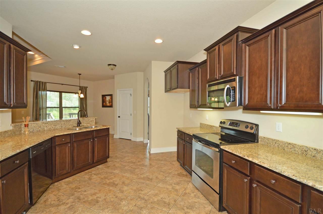 759 Lake Ridge Lane Pensacola, FL 32514 - Photo 17 of 43 a kitchen with stainless steel appliances granite countertop a sink stove and cabinets