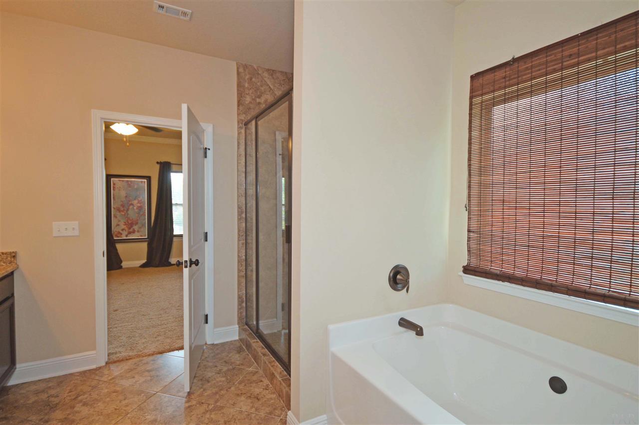 759 Lake Ridge Lane Pensacola, FL 32514 - Photo 23 of 43 a bathroom with a tub shower and a sink