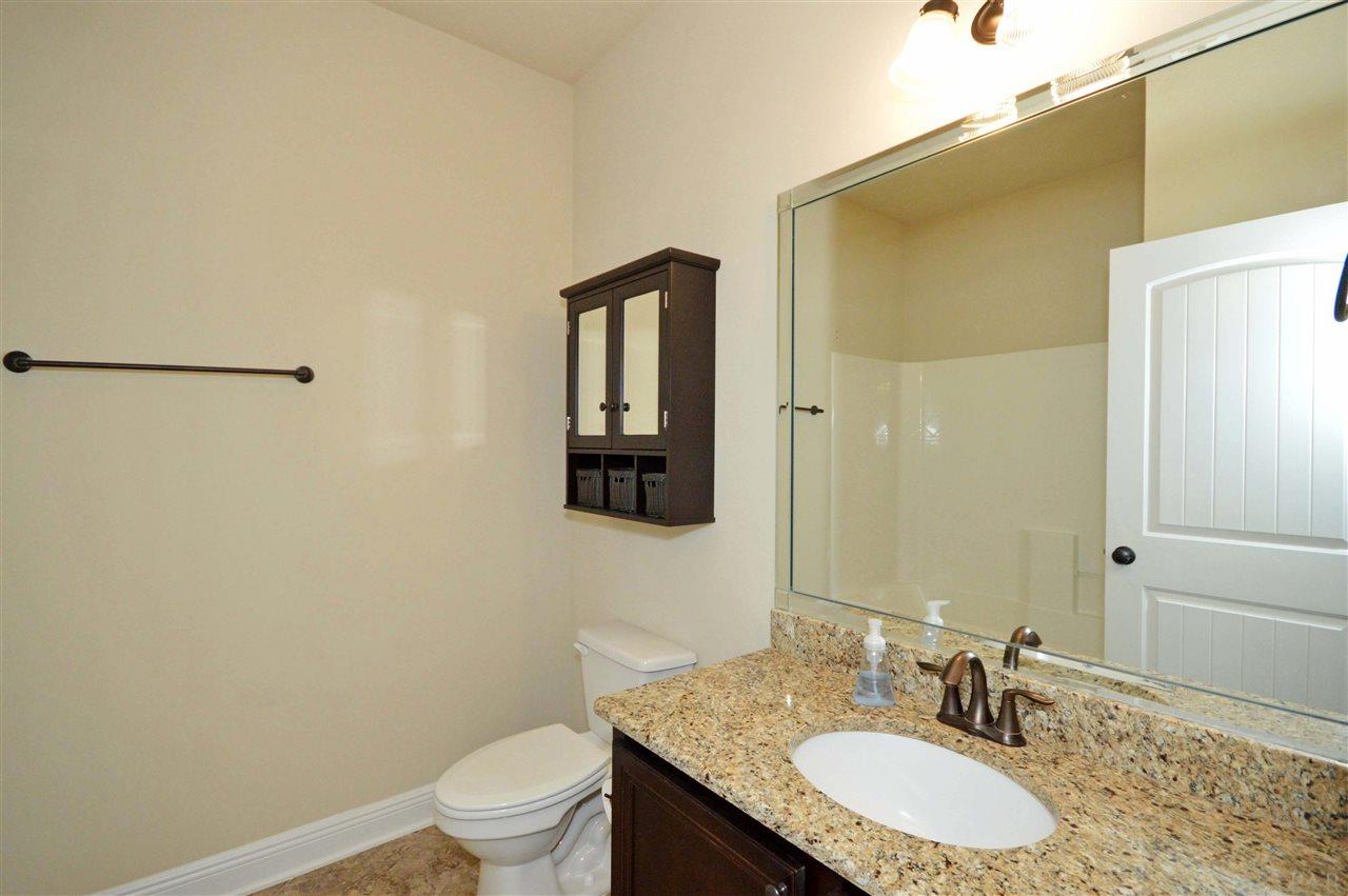 759 Lake Ridge Lane Pensacola, FL 32514 - Photo 30 of 43 a bathroom with a granite countertop sink a toilet and a mirror