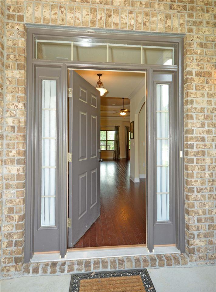 759 Lake Ridge Lane Pensacola, FL 32514 - Photo 4 of 43 a view of a hallway with wooden floor and a living room