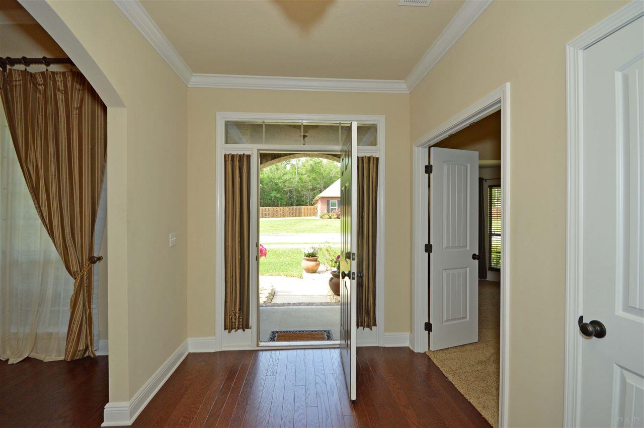 759 Lake Ridge Lane Pensacola, FL 32514 - Photo 41 of 43 a view of a hallway with wooden floor and glass door