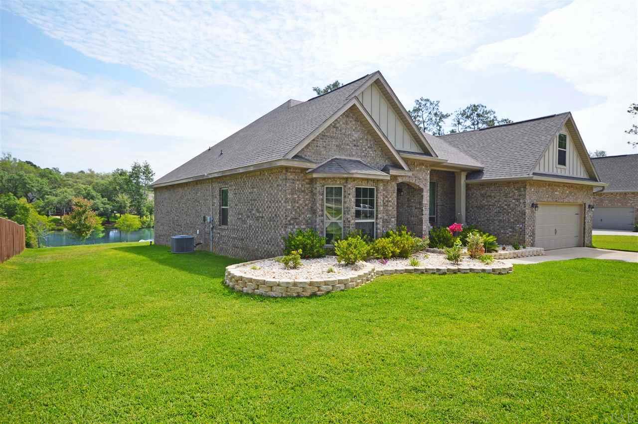 759 Lake Ridge Lane Pensacola, FL 32514 - Photo 43 of 43 a front view of a house with a garden and porch