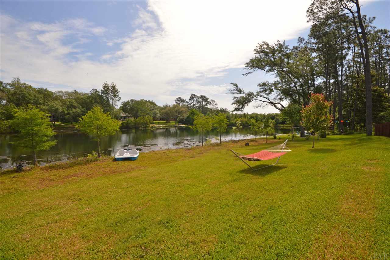 759 Lake Ridge Lane Pensacola, FL 32514 - Photo 6 of 43 a view of swimming pool with an outdoor space and seating area