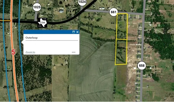 an aerial view of a house with yard