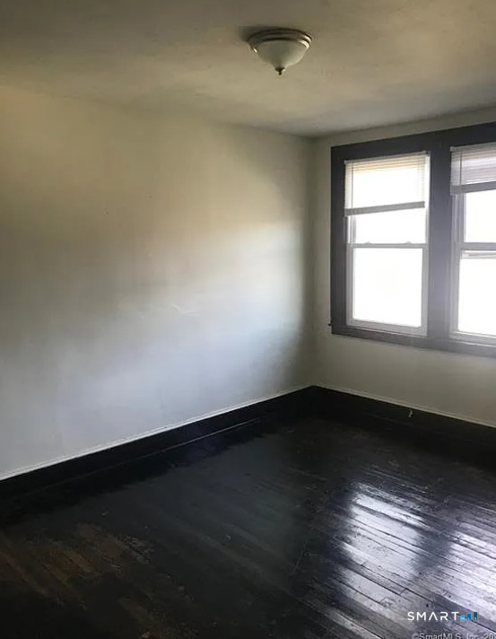 23 # 3 Clinton Avenue Middletown, CT 06457 - Photo 4 of 7 an empty room with wooden floor and windows