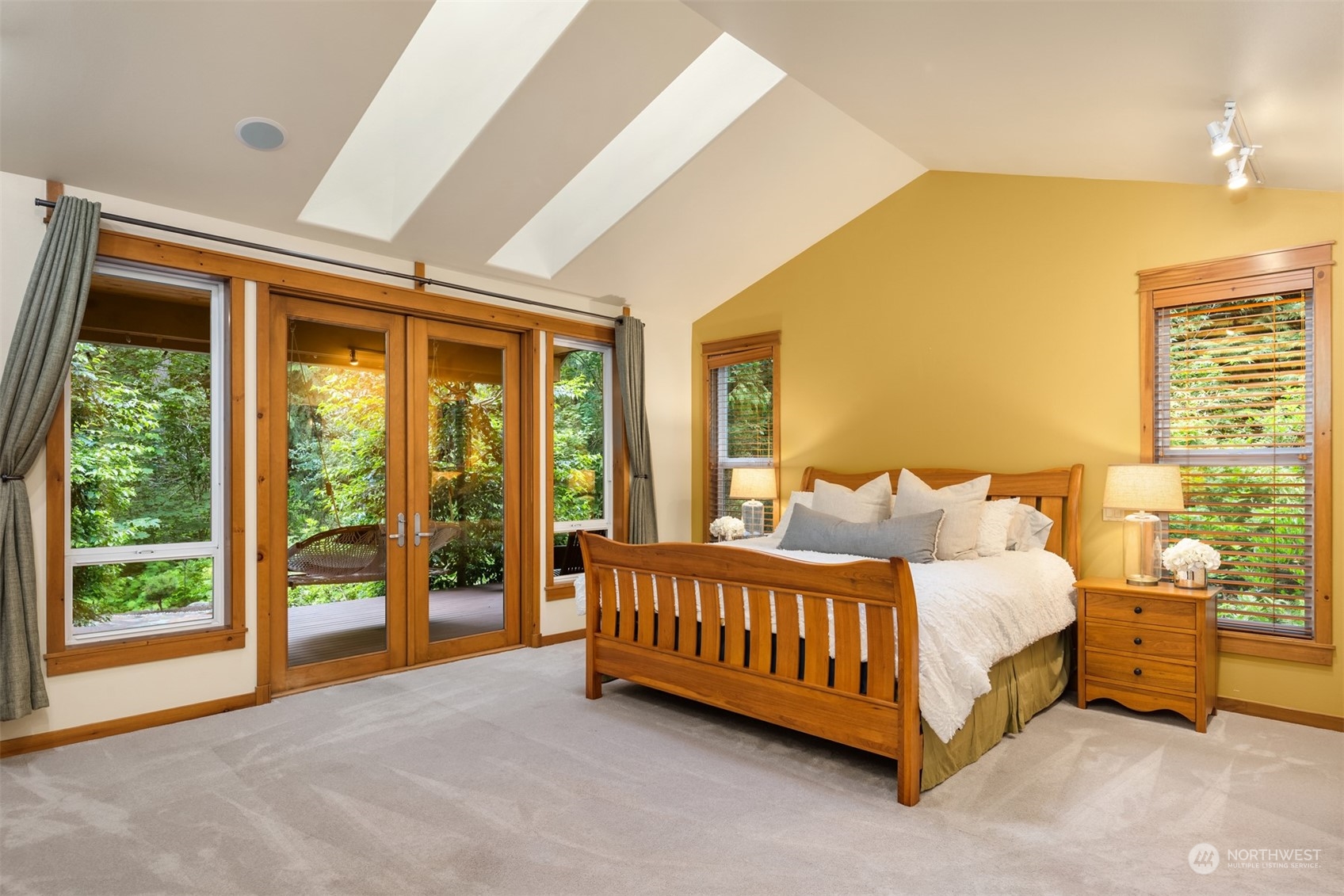 11417 Kelly Road Northeast Carnation, WA 98014 - Photo 12 of 39 a bedroom with a bed lamp and a large window