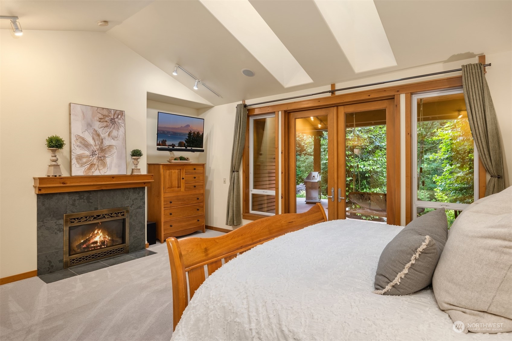 11417 Kelly Road Northeast Carnation, WA 98014 - Photo 15 of 39 a bedroom with a balcony a bed and a fireplace