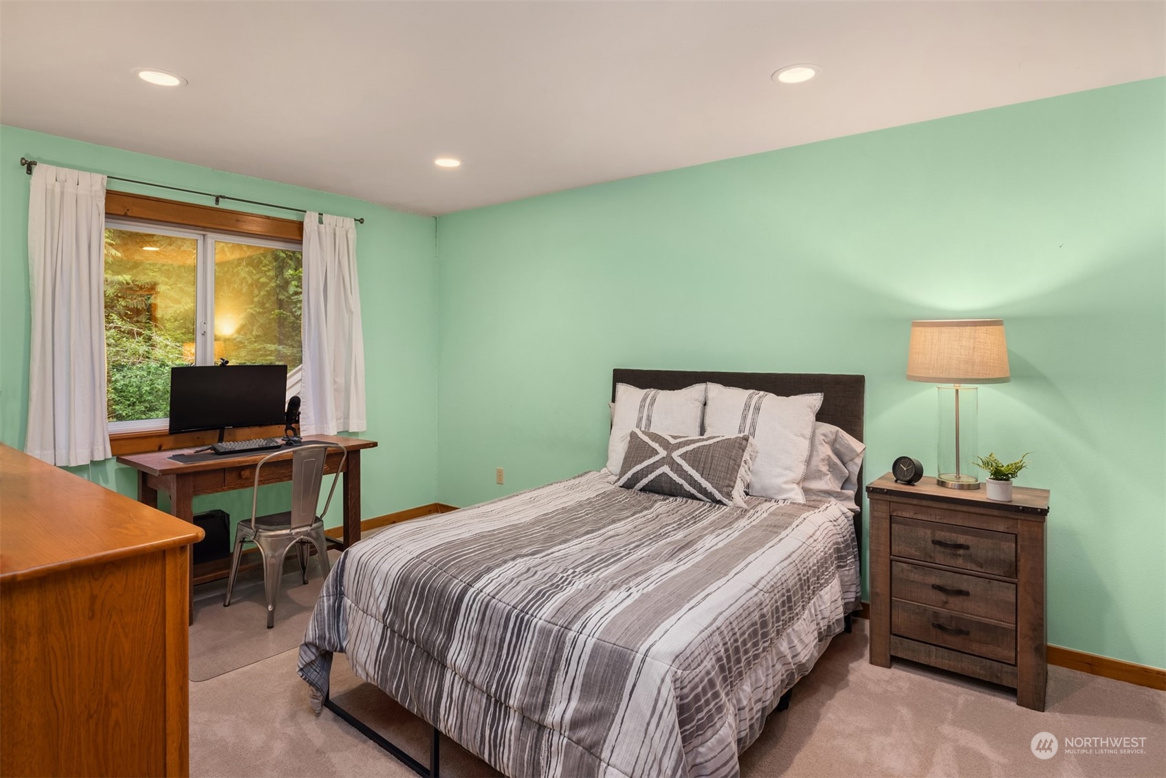 11417 Kelly Road Northeast Carnation, WA 98014 - Photo 17 of 39 a bedroom with a bed and a flat screen tv