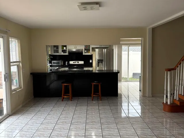 a view of kitchen with refrigerator and window