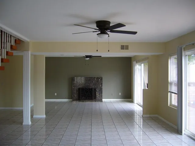 a view of a livingroom with a fireplace and window