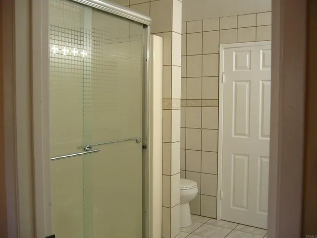 a bathroom with a toilet and a shower