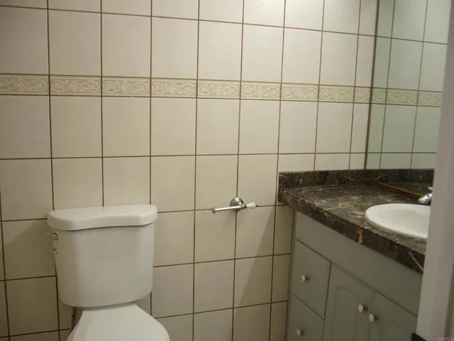 a bathroom with a sink toilet and a mirror