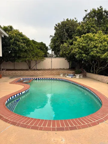 a view of a swimming pool with a backyard