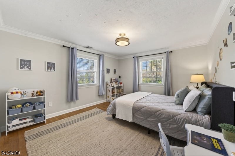 28 Spring Ridge Drive Berkeley Heights, NJ 07922 - Photo 24 of 46 a bedroom with a bed and wooden floor