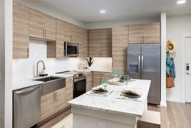 a kitchen with stainless steel appliances kitchen island granite countertop a sink and cabinets