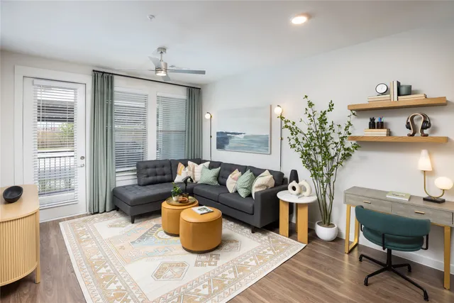 a living room with furniture and a potted plant