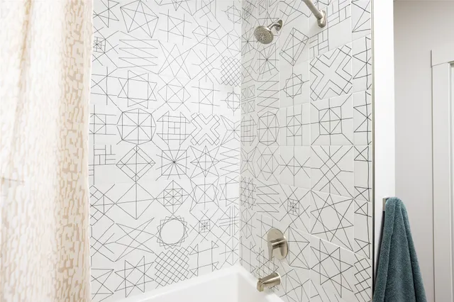 a bathroom with a shower curtain and a shower curtain