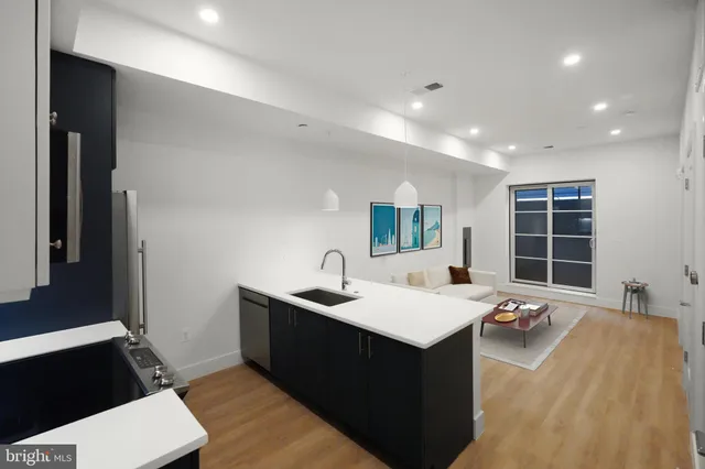 a living room with a sink furniture and a large window