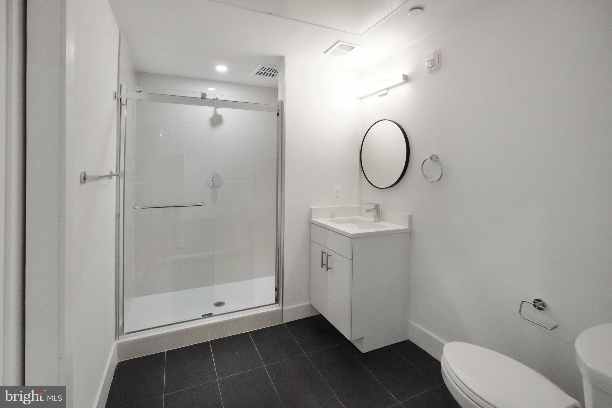2310 4th Street Northeast, Unit 2 Washington, DC 20002 - Photo 9 of 31 a bathroom with a toilet sink vanity and shower