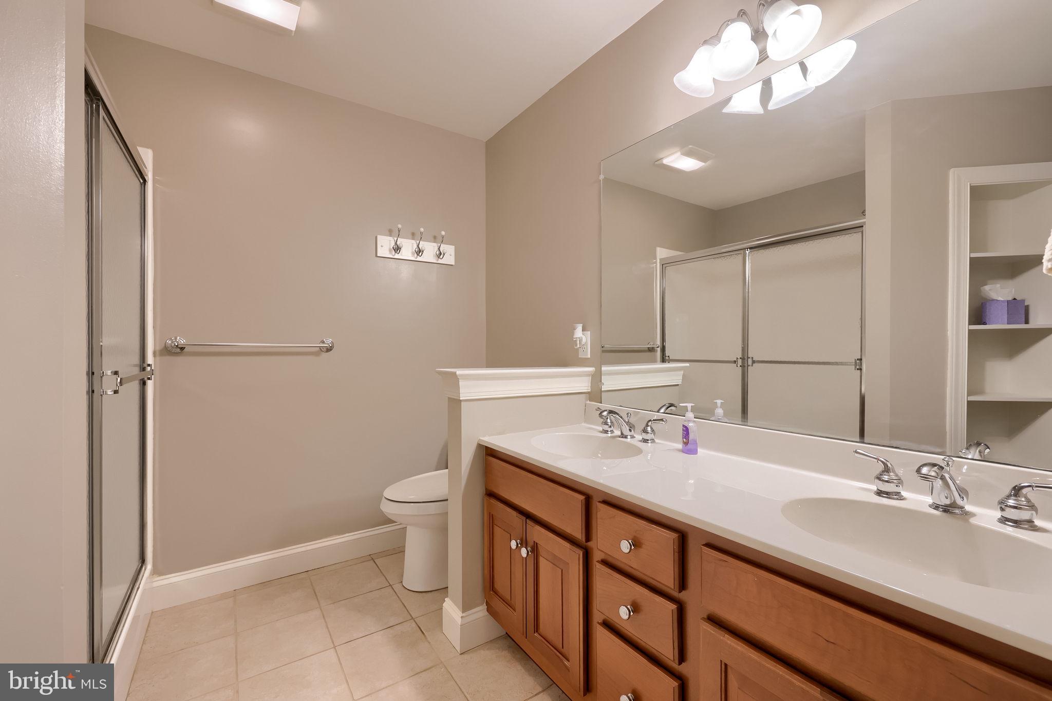 147 Fieldcrest Lane Ephrata, PA 17522 - Photo 25 of 47 a bathroom with a double vanity sink toilet and a mirror