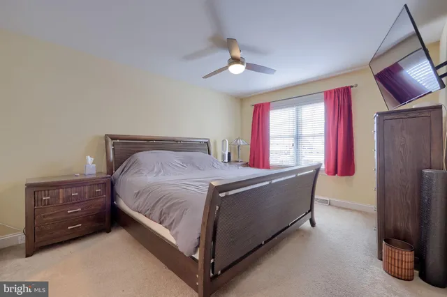 a bed sitting in a room next to a window