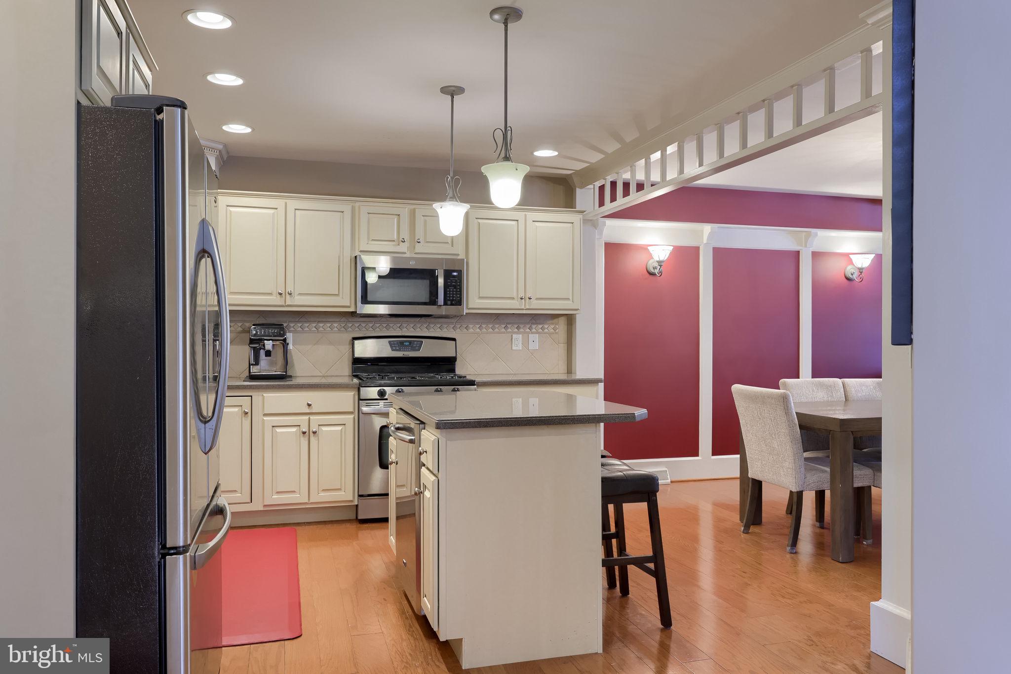 147 Fieldcrest Lane Ephrata, PA 17522 - Photo 7 of 47 a kitchen with stainless steel appliances granite countertop a stove a refrigerator a oven a sink with a dining table and chairs