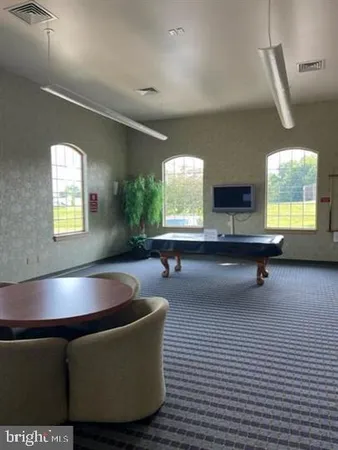 a living room with couches and a flat screen tv