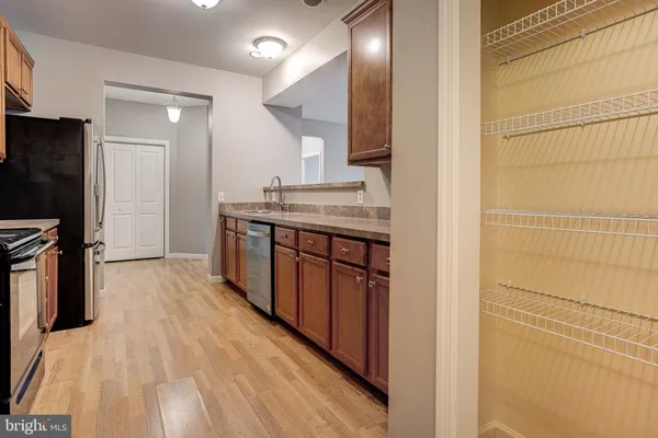 a kitchen with stainless steel appliances granite countertop a stove and a refrigerator