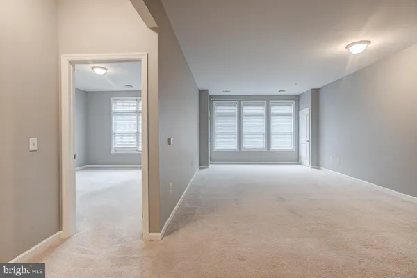 an empty room with windows and closet