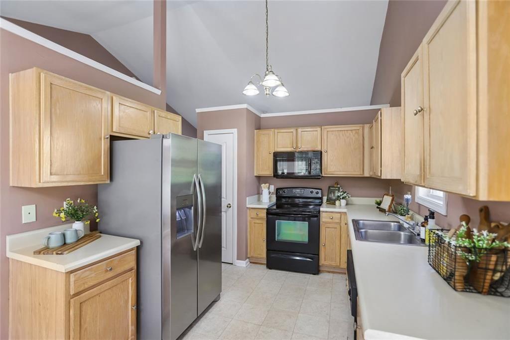9720 Poole Road Villa Rica, GA 30180 - Photo 10 of 40 a kitchen with stainless steel appliances granite countertop a refrigerator a stove a sink and a refrigerator