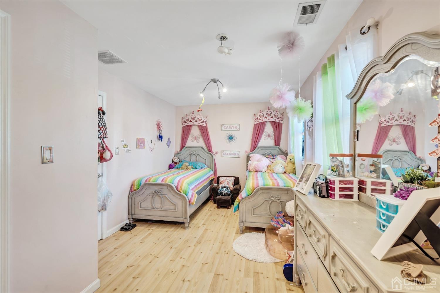 229 Halsted Road Elizabeth, NJ 07208 - Photo 22 of 37 a bedroom with furniture and a wooden floor