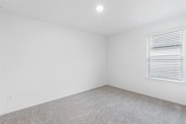 a view of an empty room and a window