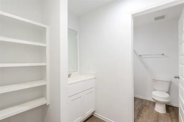 a white toilet sitting next to a bathroom sink