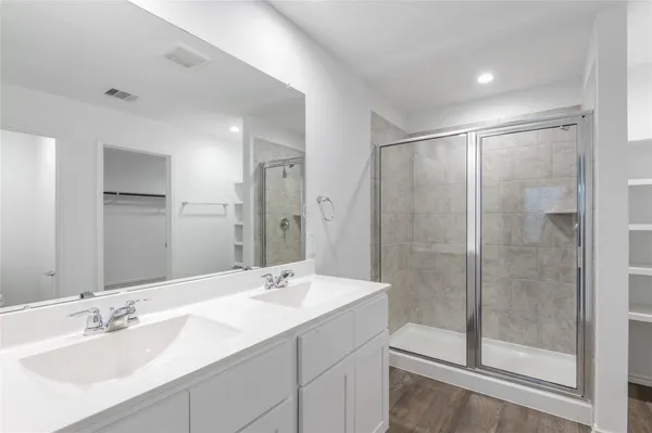 a bathroom with a shower sink and mirror