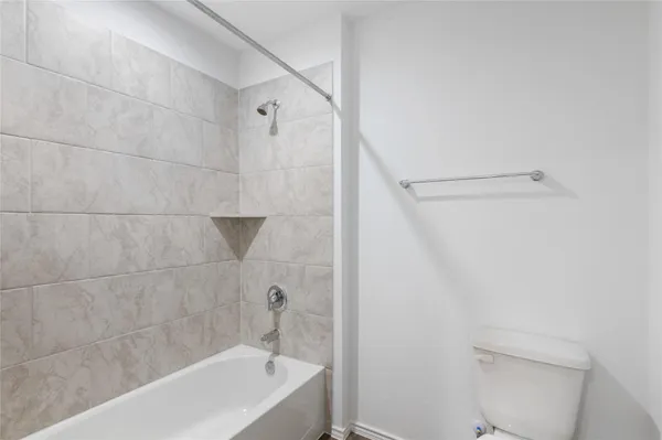 a bathroom with a bathtub and a toilet