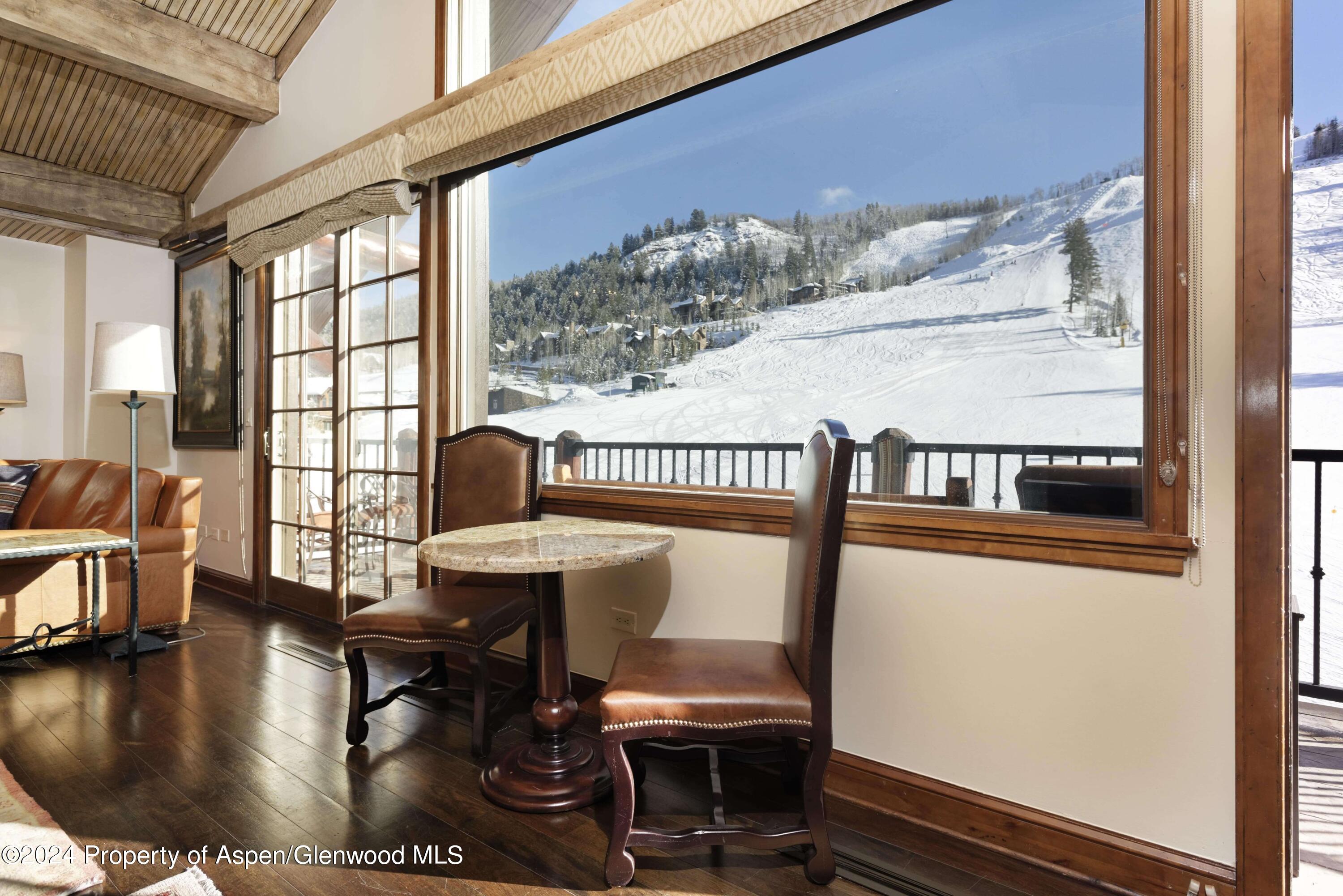 133 Prospector Road, Unit 43016 Aspen, CO 81611 - Photo 9 of 21 a view of a dining room with furniture window and wooden floor