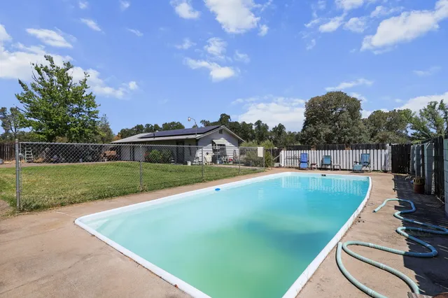 a view of a swimming pool with a yard