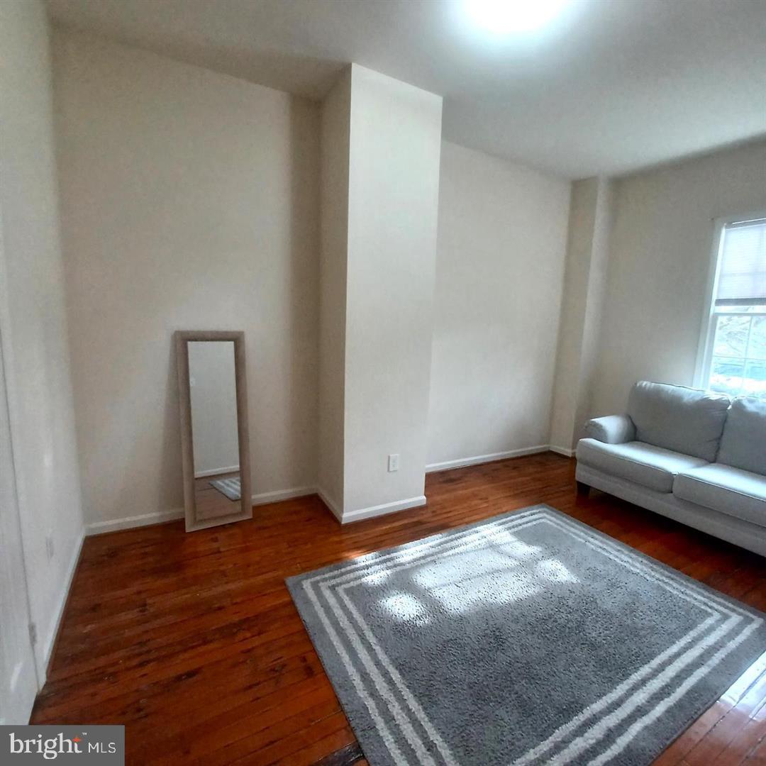 301 North West Street, Unit 1 Alexandria, VA 22314 - Photo 3 of 16 a living room with furniture and a rug