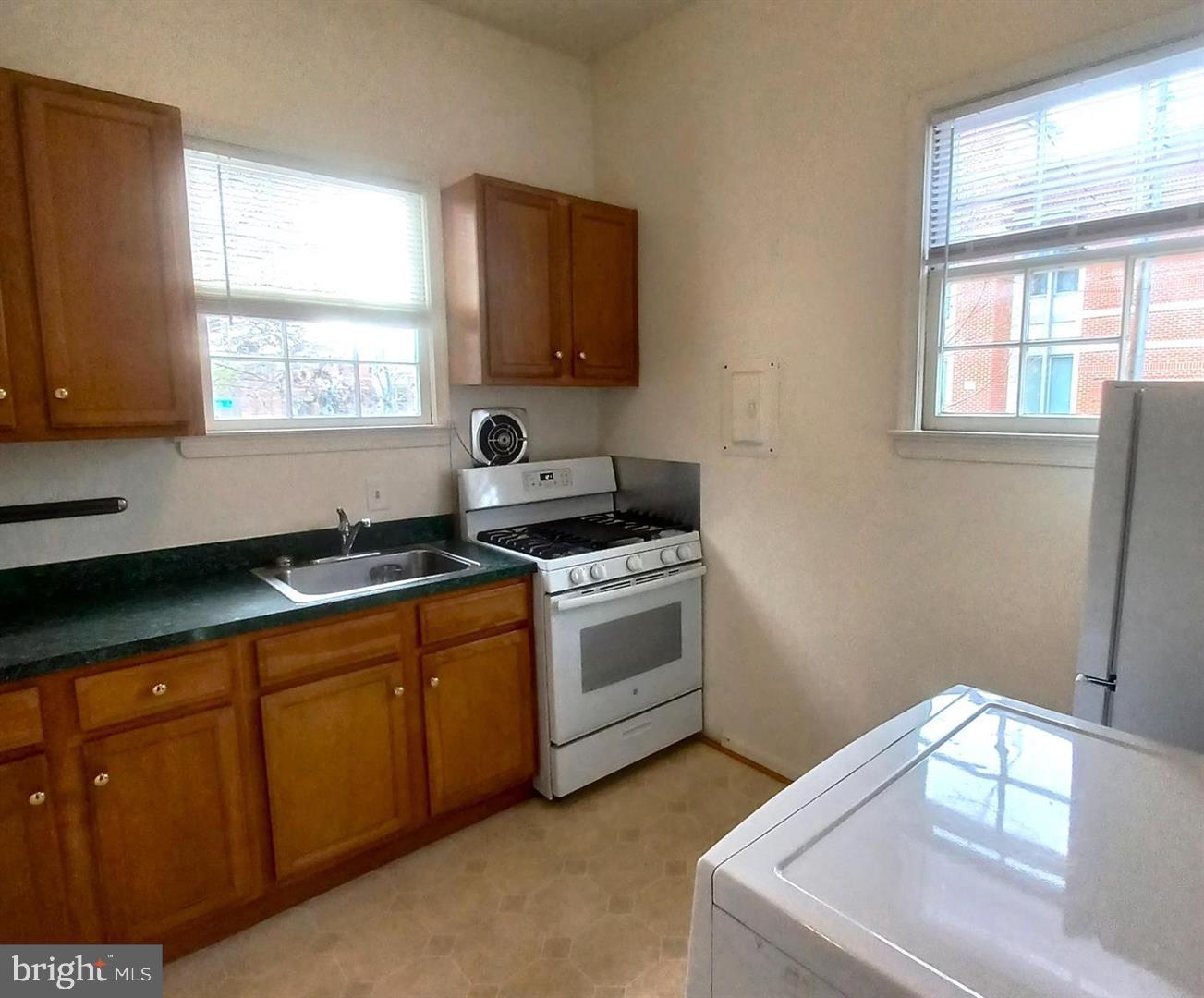 301 North West Street, Unit 1 Alexandria, VA 22314 - Photo 7 of 16 a kitchen with sink a window and stainless steel appliances