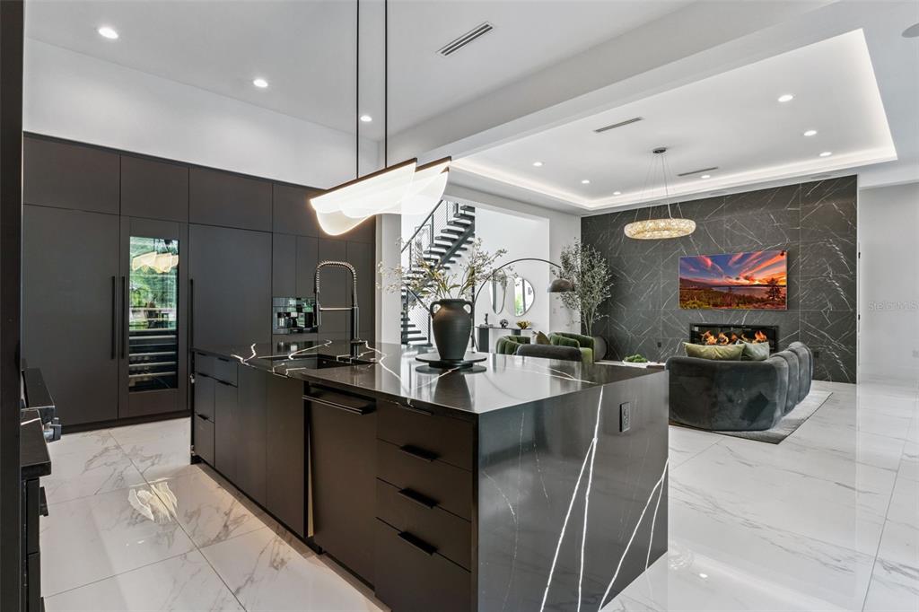 15746 Pendio Drive Montverde, FL 34756 - Photo 12 of 71 a kitchen with stainless steel appliances granite countertop a sink and a refrigerator