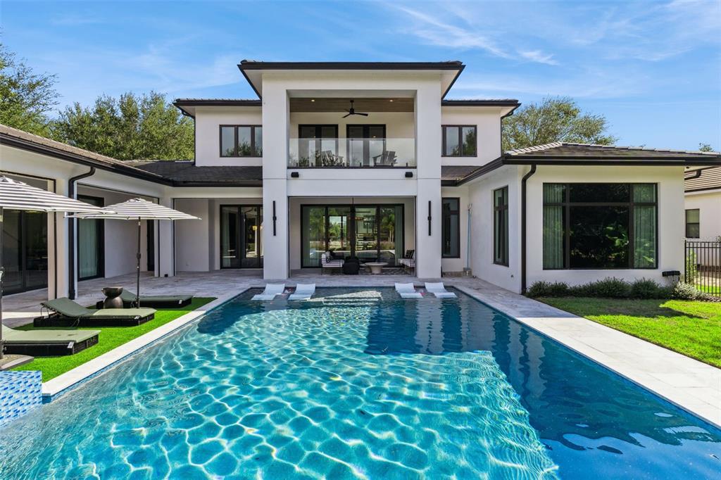 15746 Pendio Drive Montverde, FL 34756 - Photo 2 of 71 a view of a house with swimming pool and a yard
